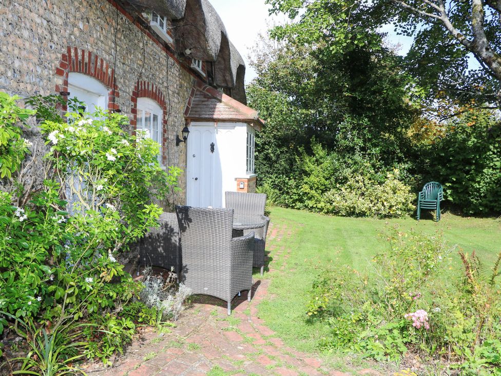 A garden with seating arrangement and door at Little Owl in High Cross near Petersfield