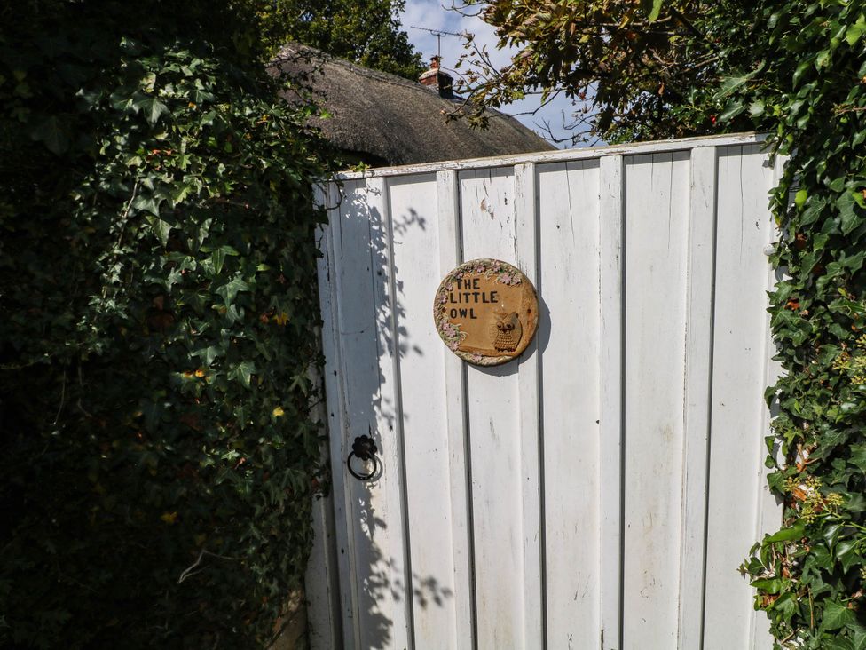 A gate with a wooden sign at The Little Owl in High Cross near Petersfield