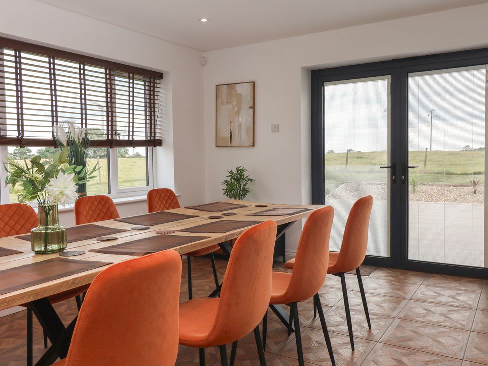 A dining room with a table and chairs at Gravel Pit Cottage in Bridlington