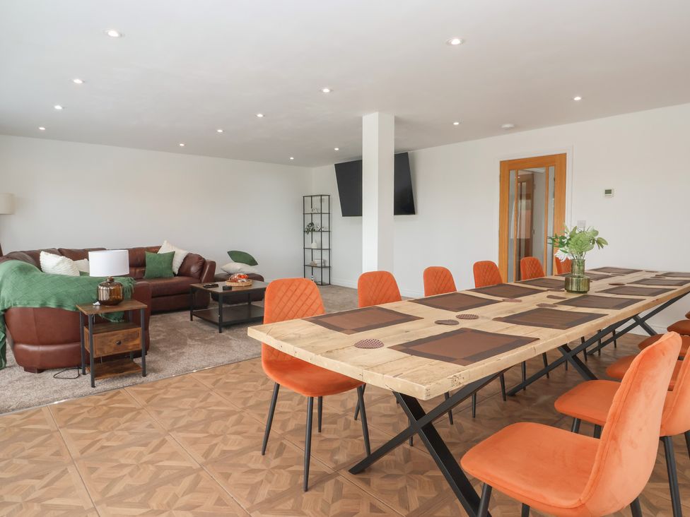 A dining room with a large table and chairs at Gravel Pit Cottage in Bridlington