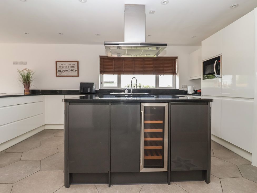 A kitchen with a central island and modern appliances at Gravel Pit Cottage in Bridlington