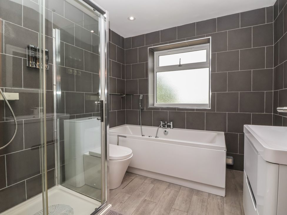 A bathroom with a bathtub, shower, and toilet at Gravel Pit Cottage, Bridlington