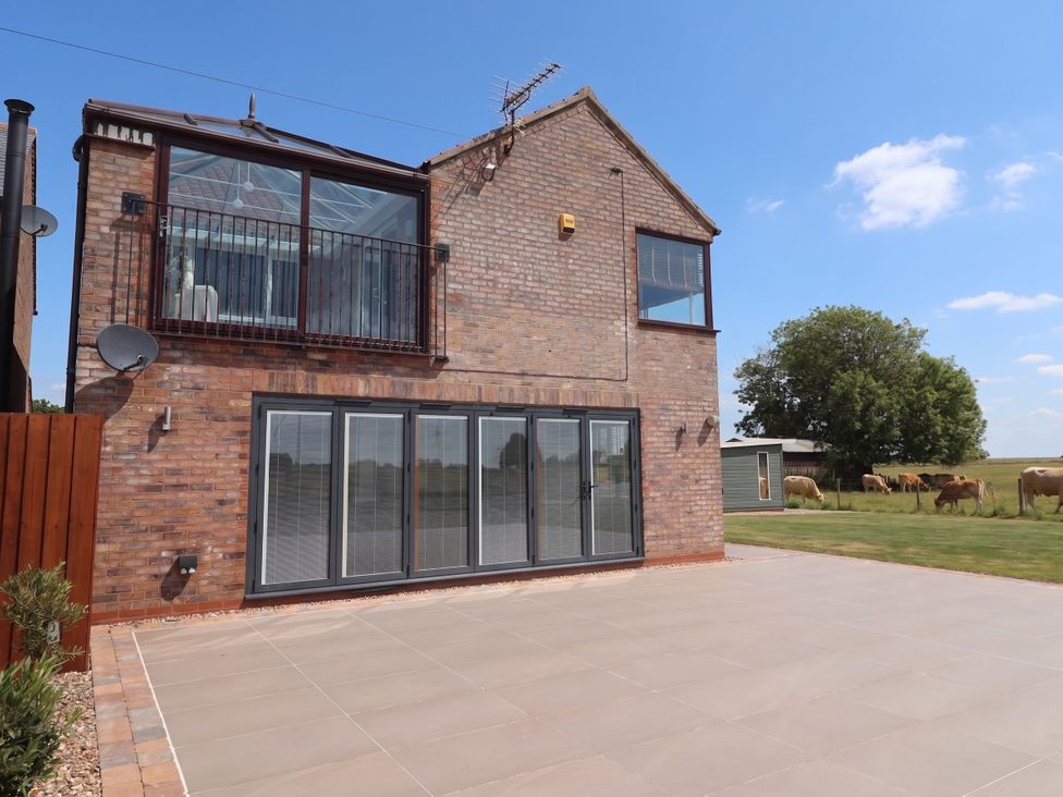 An outdoor view of a house with a balcony at Gravel Pit Cottage in Bridlington