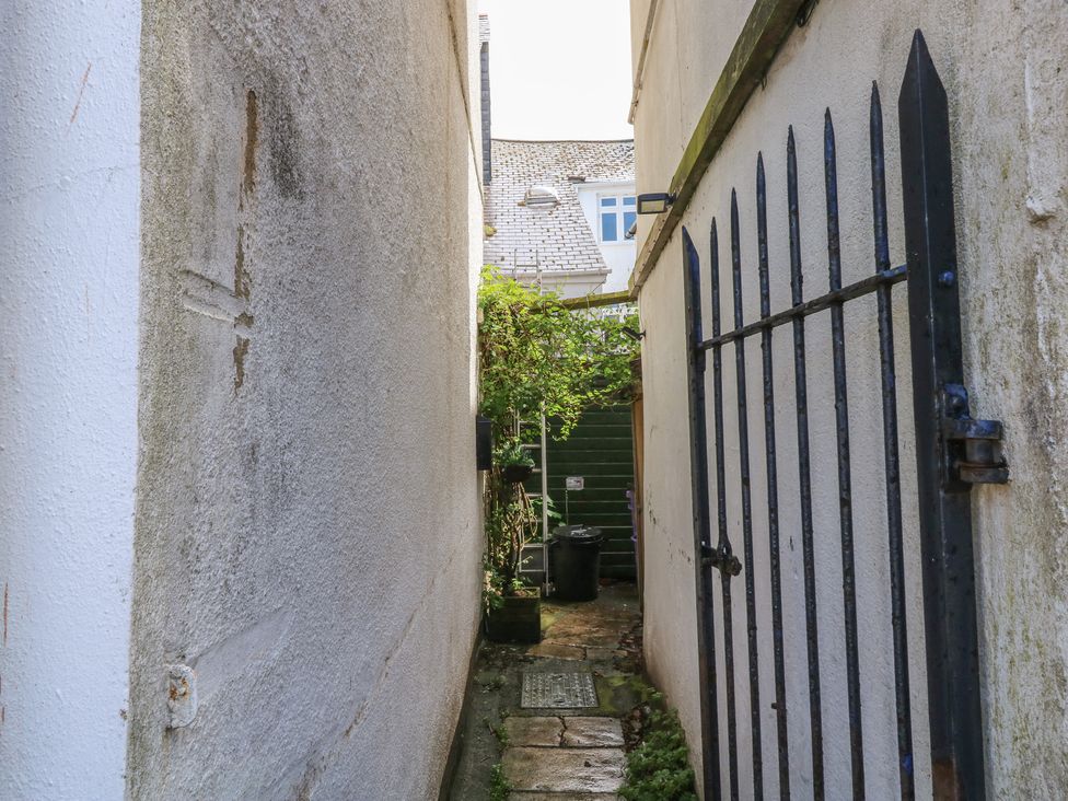 An outdoor pathway with a gate and greenery at 15D Foss Street in Dartmouth