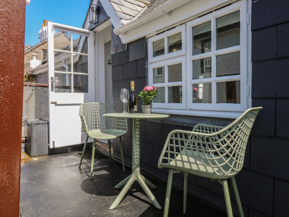 An outdoor seating area with a table and chairs at 15D Foss Street in Dartmouth