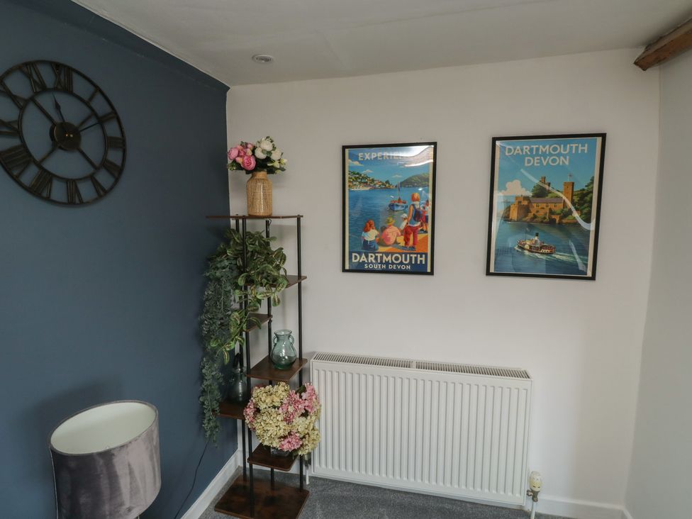 A living room with a wall clock and decorative wall art at 15D Foss Street Dartmouth