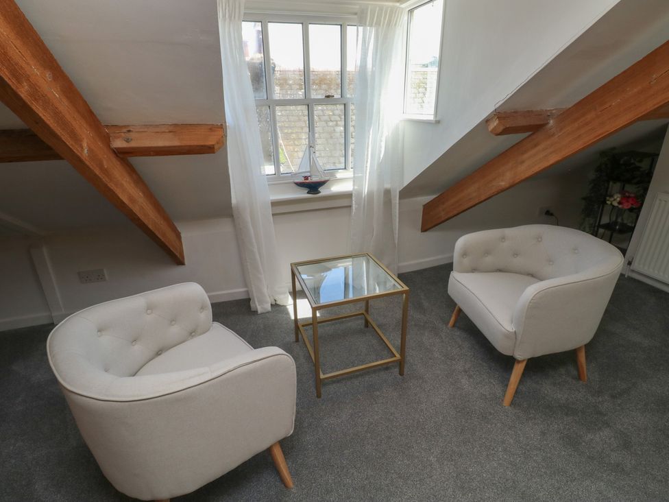 A living room with two chairs and a glass coffee table at 15D Foss Street, Dartmouth