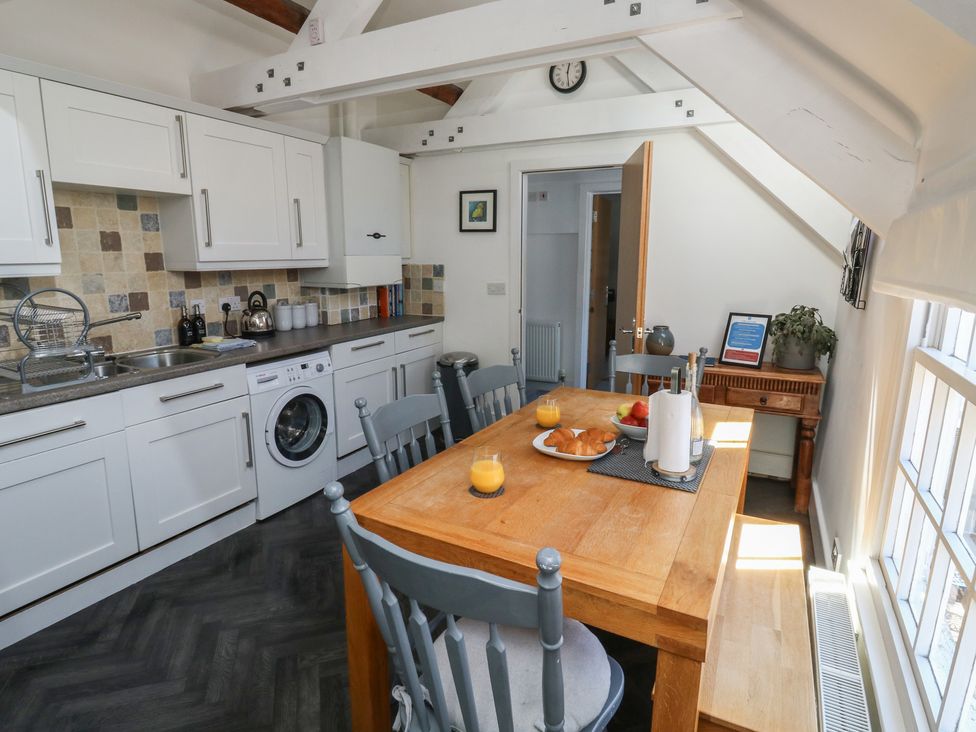 A kitchen with a dining table and chairs at 15D Foss Street in Dartmouth