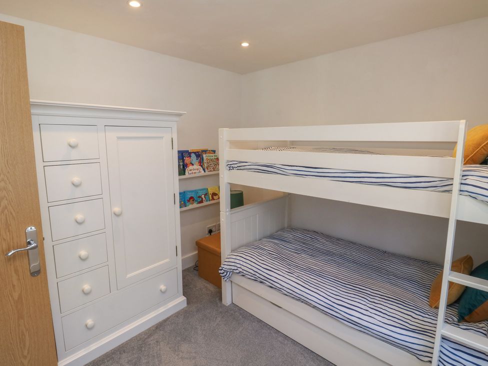 A bedroom with a bunk bed and a chest of drawers at 15D Foss Street in Dartmouth