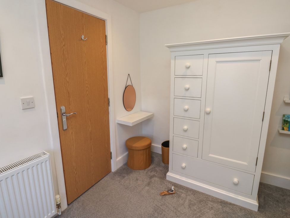 A bedroom with storage furniture and a door at 15D Foss Street in Dartmouth