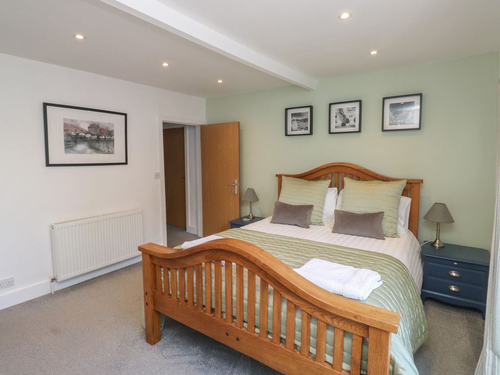 A bedroom with a bed and photographs on the wall at 15D Foss Street Dartmouth