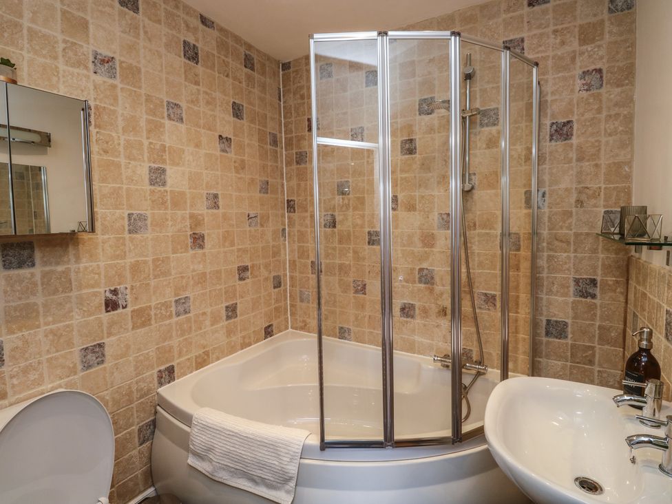 A bathroom with a shower and bathtub at 15D Foss Street in Dartmouth