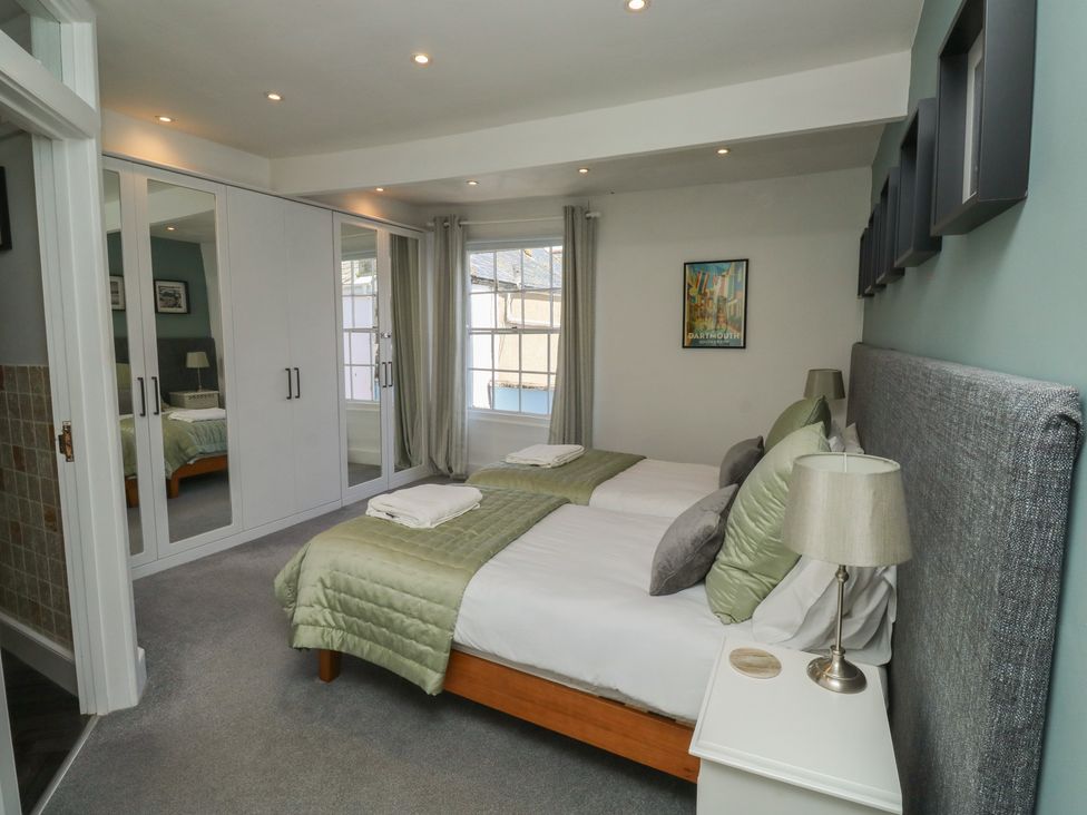 A bedroom with two beds and a wardrobe at 15D Foss Street in Dartmouth