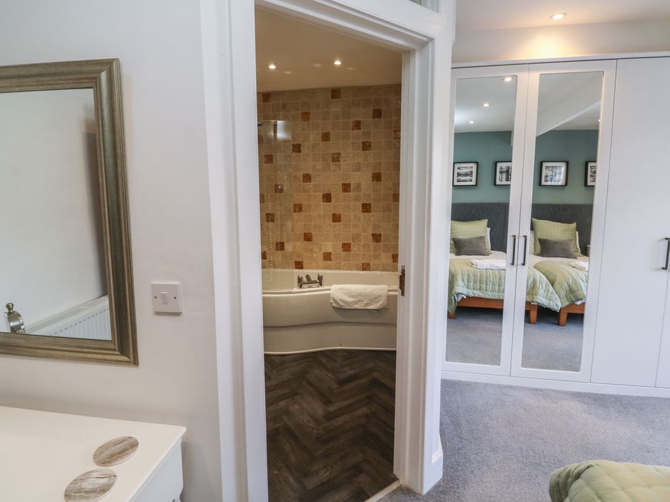 A bedroom with a bathtub visible in an adjacent bathroom at 15D Foss Street Dartmouth