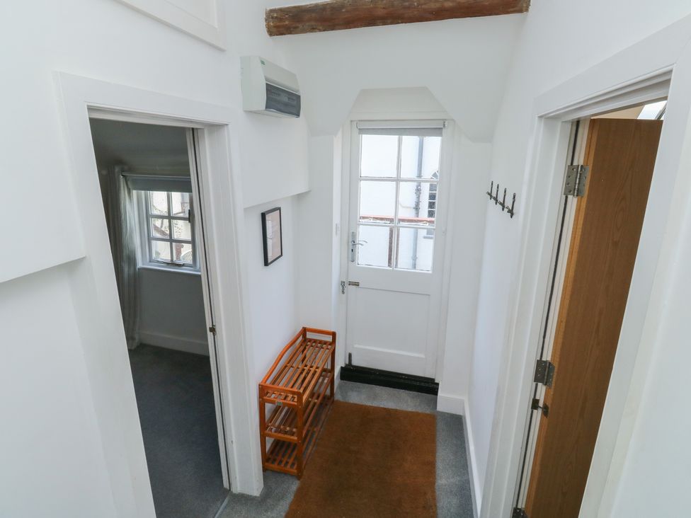 A hallway with a door and hooks for coats at 15D Foss Street in Dartmouth