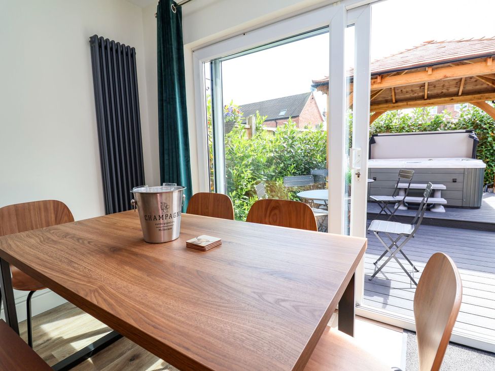 A dining room with a table and chairs at 2 Rookery Close Nantwich