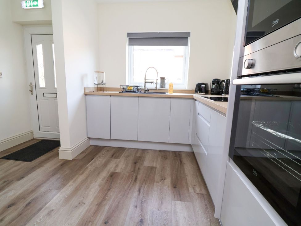 A kitchen with cabinets and appliances at 2 Rookery Close Nantwich