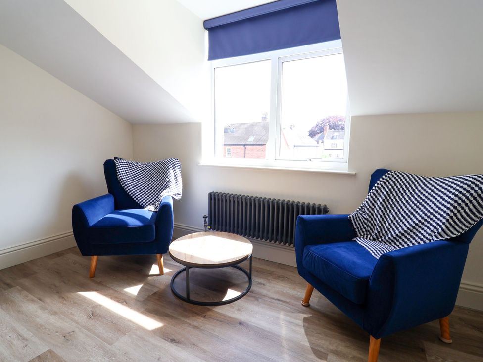 A living room with two armchairs and a coffee table at 2 Rookery Close in Nantwich