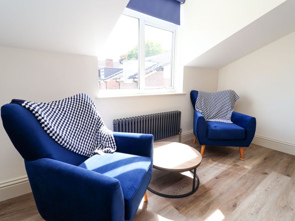 A sitting room with two armchairs and a coffee table at 2 Rookery Close Nantwich