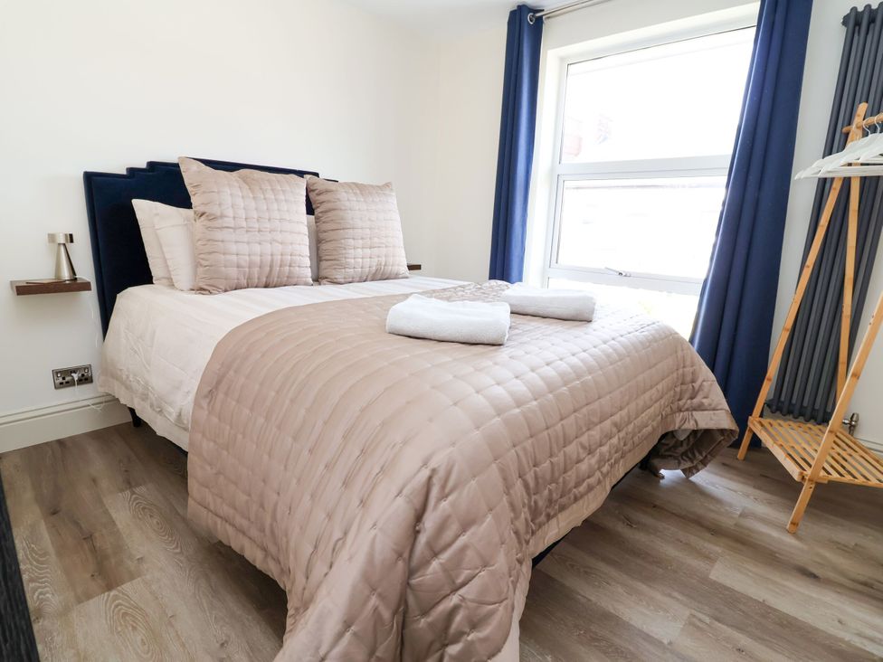 A bedroom with a bed and towels at 2 Rookery Close in Nantwich