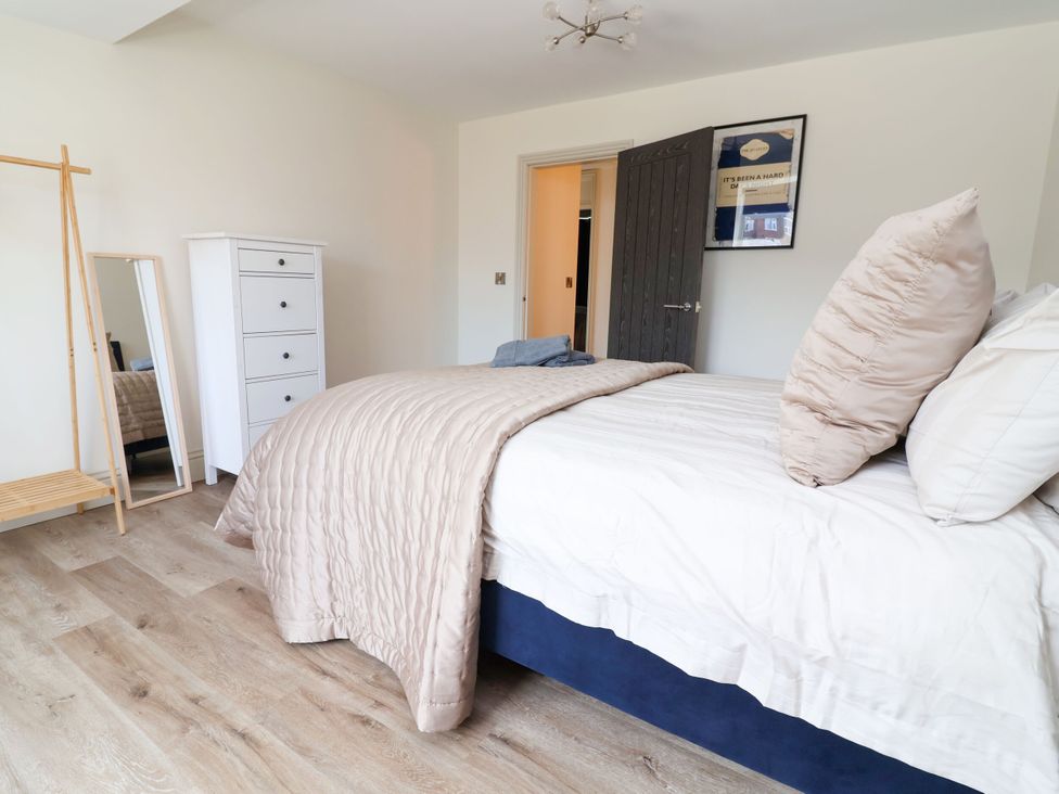 A bedroom with a bed, chest of drawers and mirror at 2 Rookery Close, Nantwich
