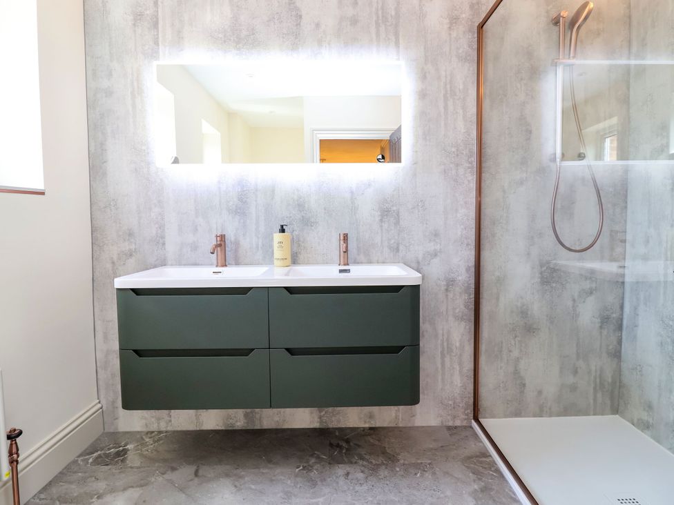 A bathroom with a sink and shower at 2 Rookery Close Nantwich
