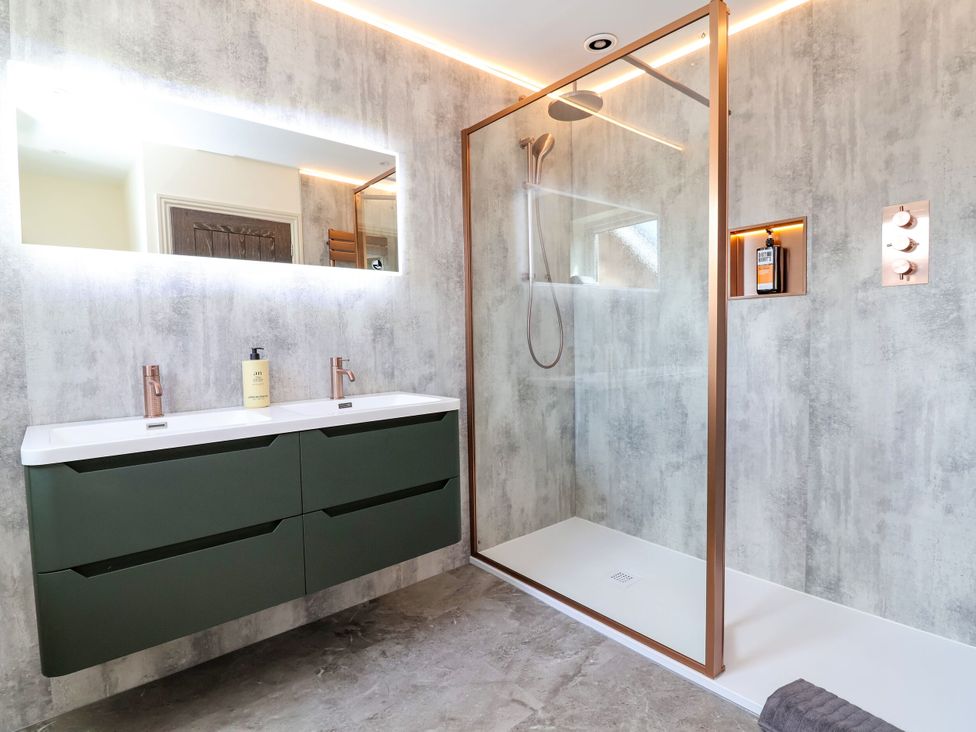 A bathroom with a shower and vanity unit at 2 Rookery Close, Nantwich
