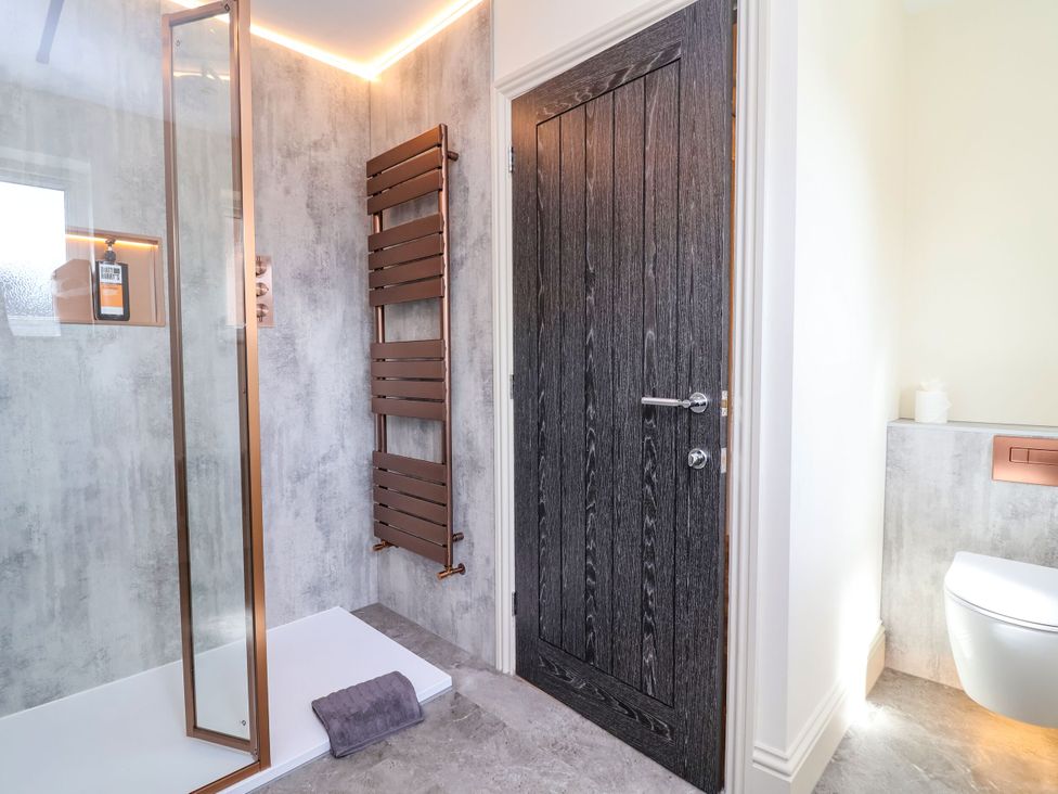 A bathroom with a shower and toilet at 2 Rookery Close in Nantwich