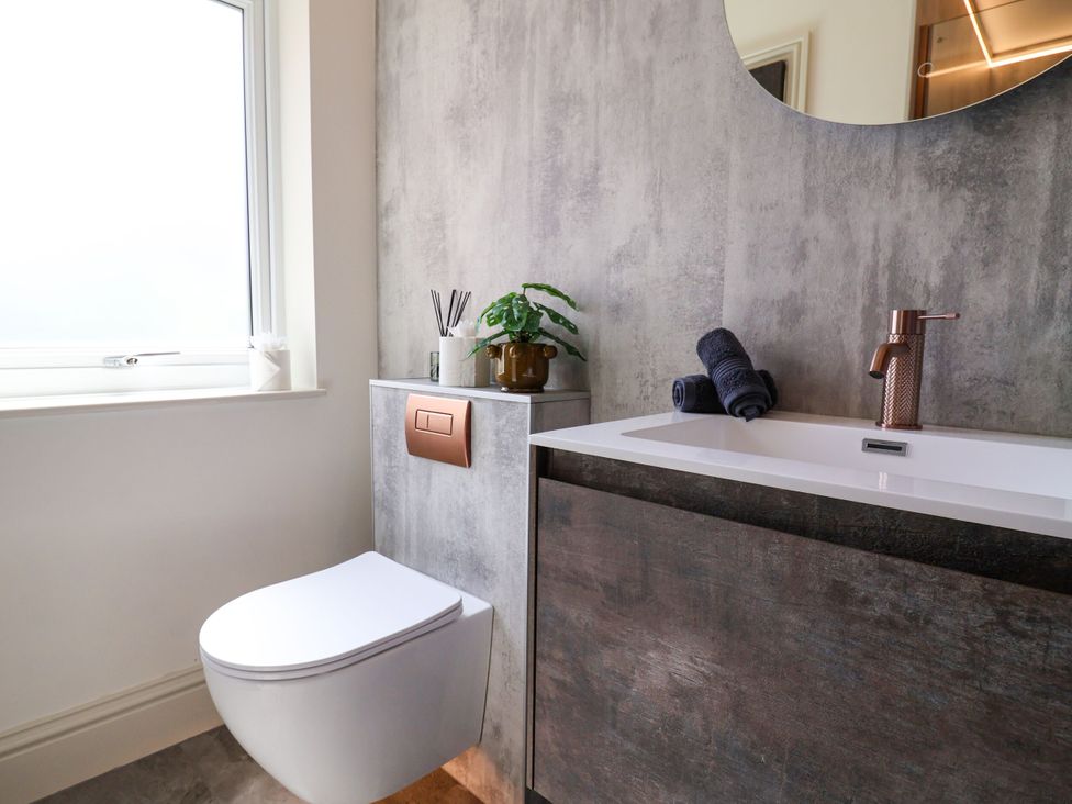 A bathroom with a toilet and sink at 2 Rookery Close, Nantwich