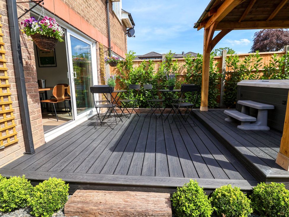 A garden with seating area and hot tub at 2 Rookery Close in Nantwich