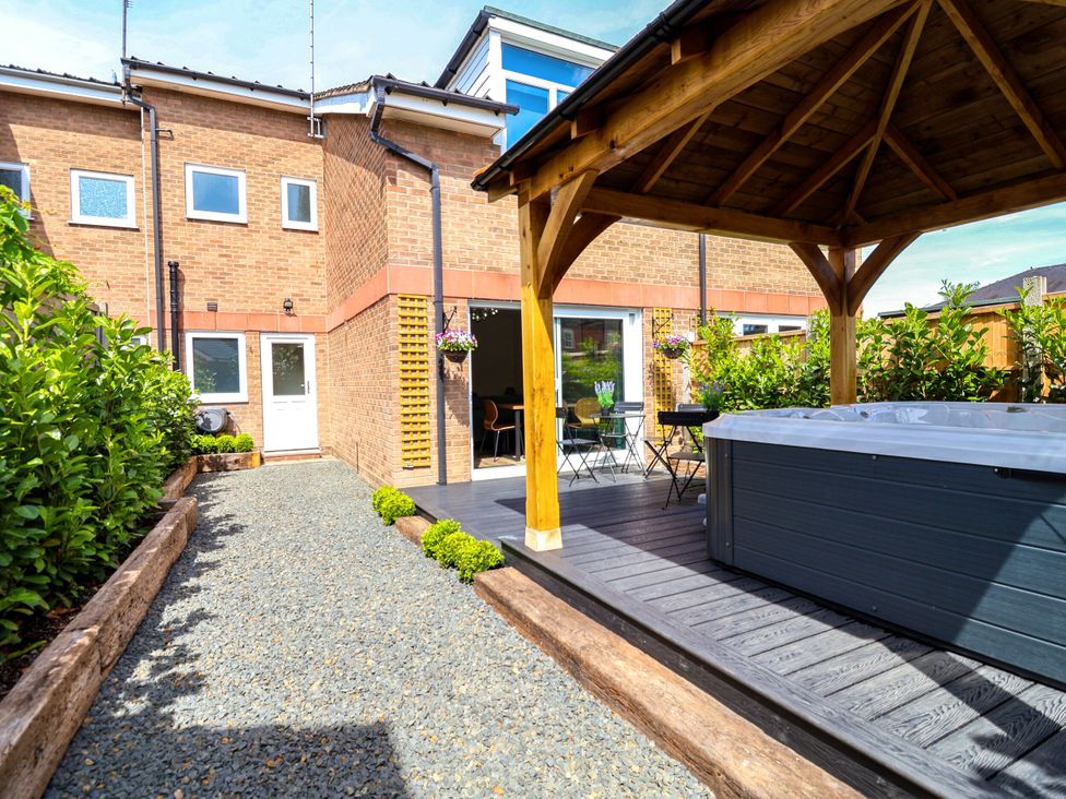 A garden with a hot tub and gazebo at 2 Rookery Close Nantwich