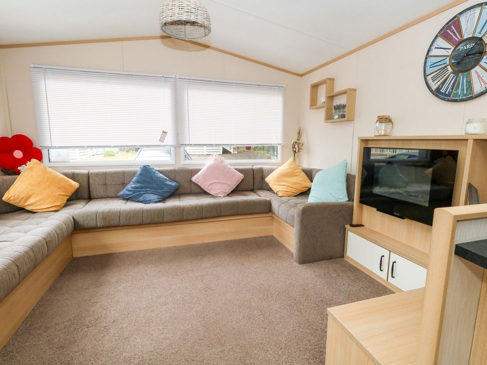 A living room with a sofa and television at Foxglove 4 in Ringwood