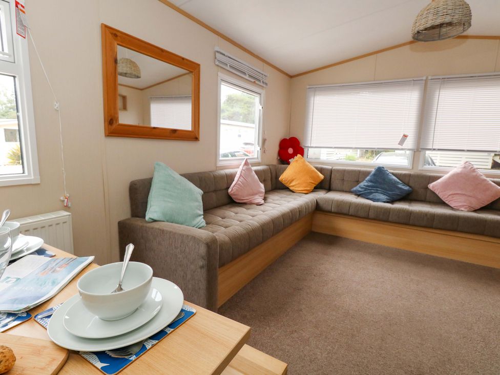 A living room with a sofa and cushions at Foxglove 4 Ringwood