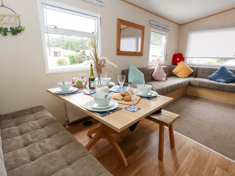 A dining area with a table set for meals at Foxglove 4 in Ringwood