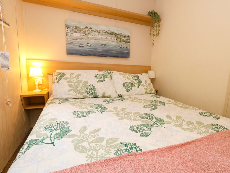 A bedroom with a bed and bedside lamp at Foxglove 4 in Ringwood