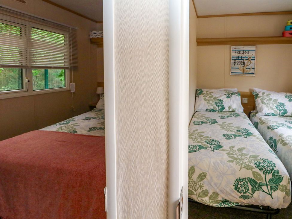 A bedroom with two single beds and a window at Foxglove 4 Ringwood
