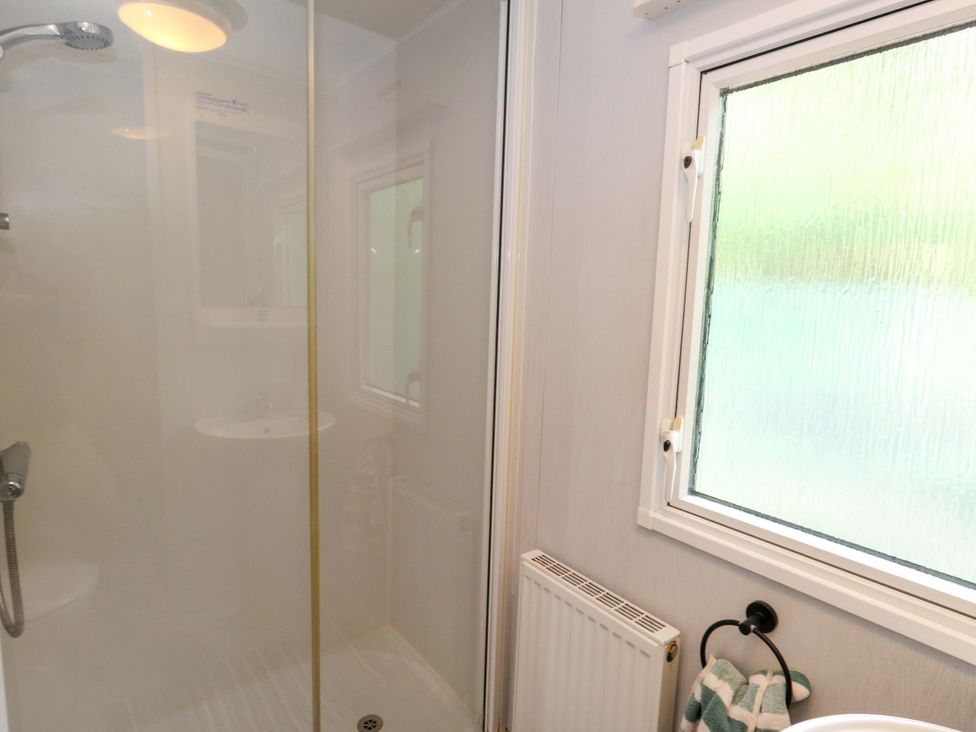 A bathroom with a shower and sink at Foxglove 4 in Ringwood