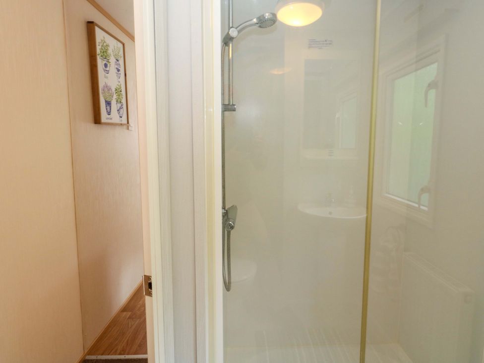 A bathroom with a shower and sink at Foxglove 4 Ringwood