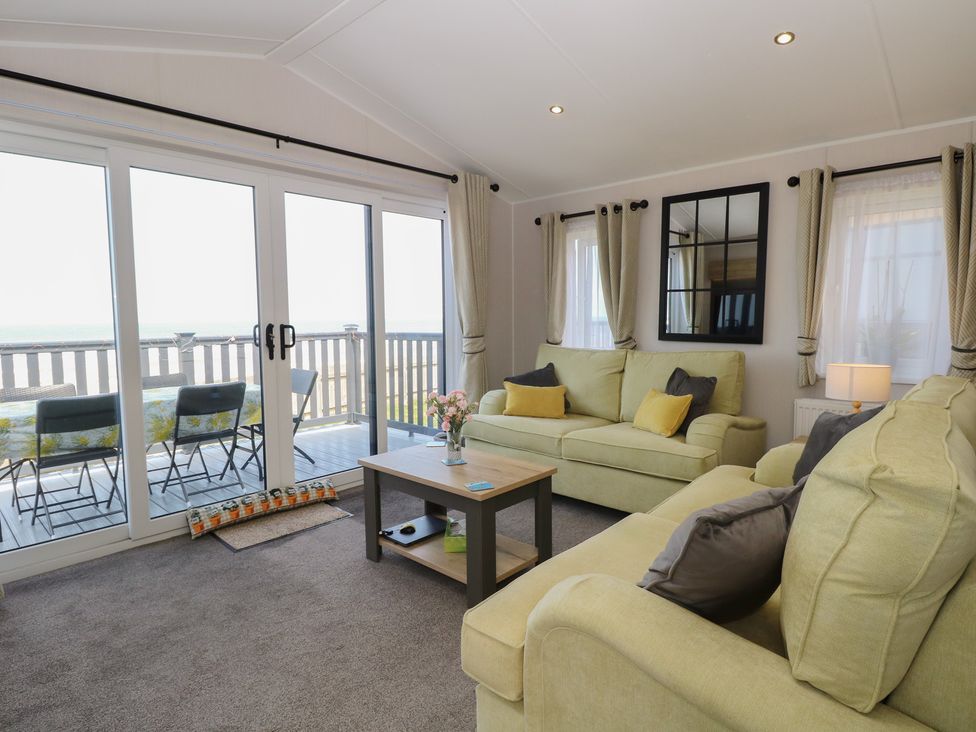 A living room with seating and a view at Plot 34 Bacton