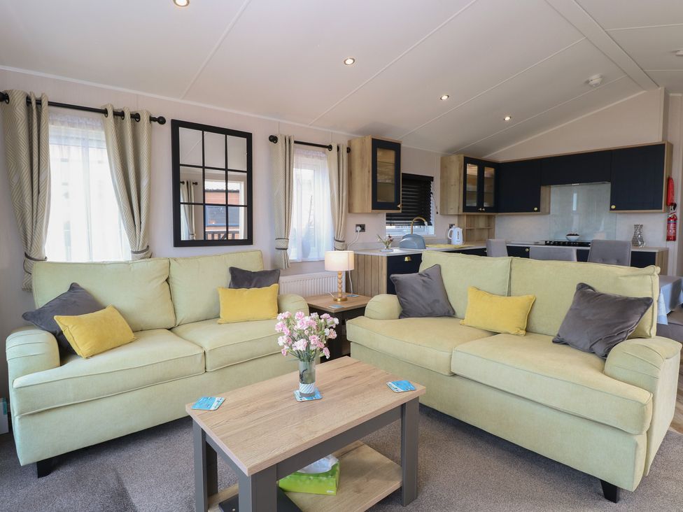 A living room with sofas and a coffee table at Plot 34 Bacton