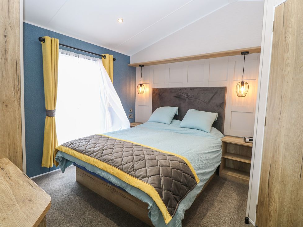 A bedroom with a bed and bedside table at Plot 34 in Bacton