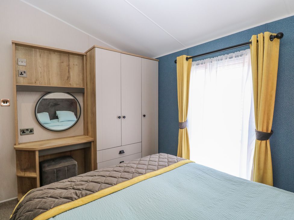 A bedroom with a bed and wardrobe at Plot 34 Bacton