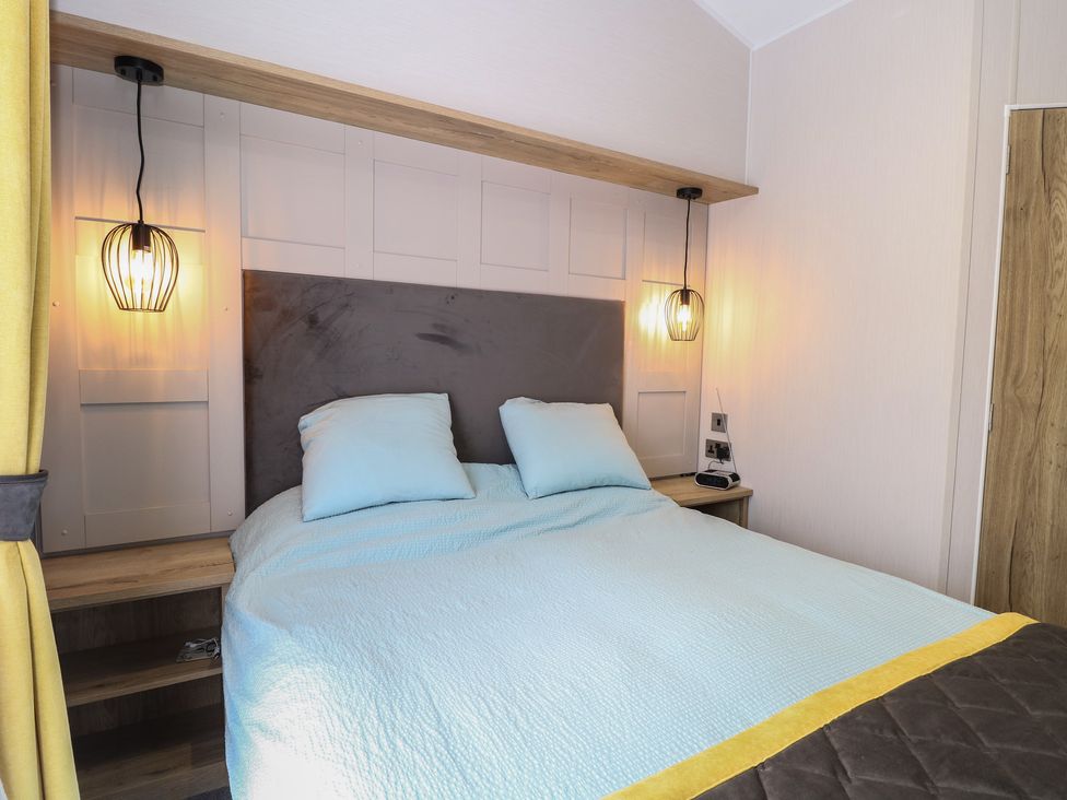A bedroom with a bed and bedside lamps at Plot 34 in Bacton