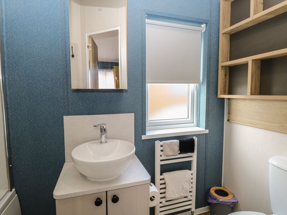 A bathroom with a sink and towel radiator at Plot 34 in Bacton