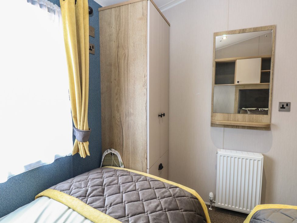 A bedroom with a bed and wardrobe at Plot 34 Bacton