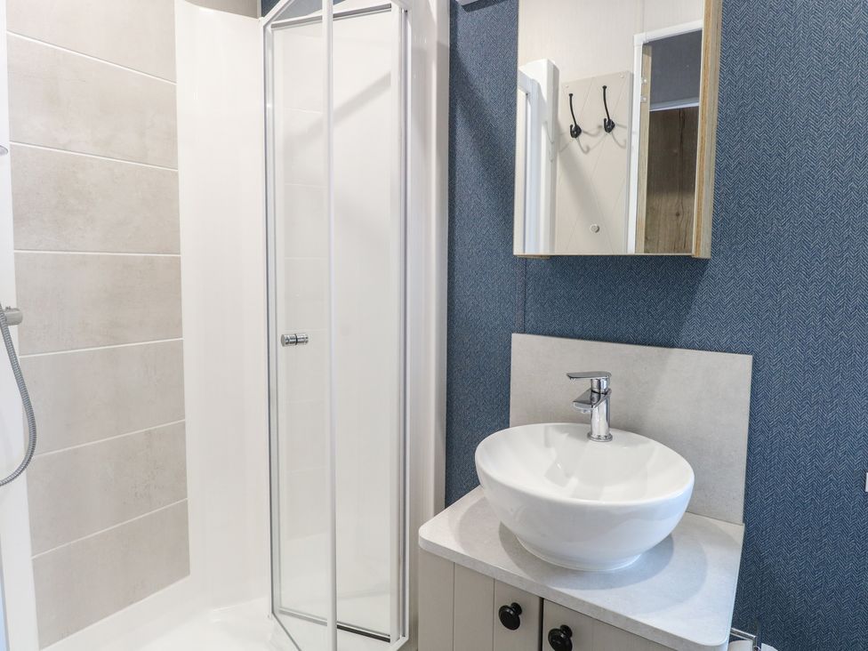 A bathroom featuring a shower and a sink at Plot 34 in Bacton