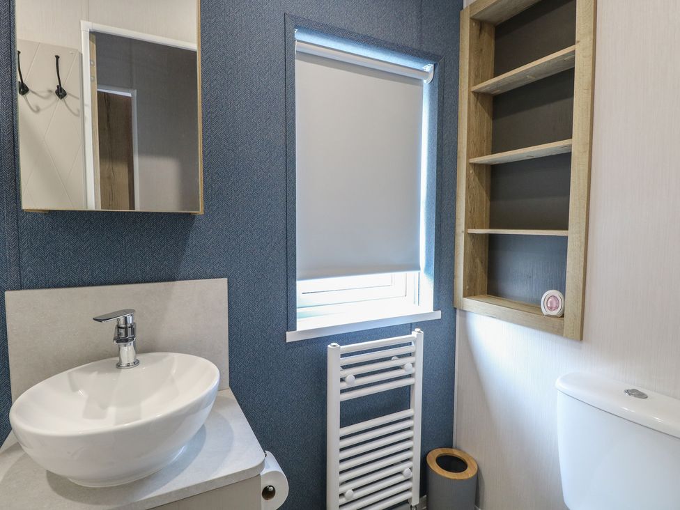 A bathroom with a sink and toilet at Plot 34 in Bacton