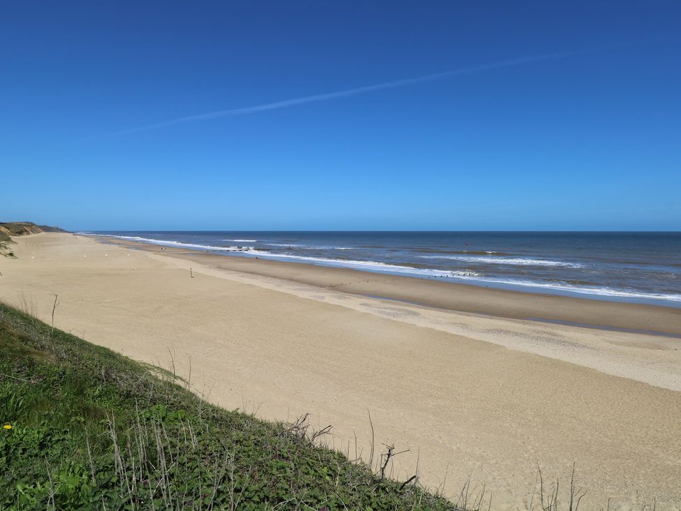 A beach with sand and water at Plot 34 Bacton
