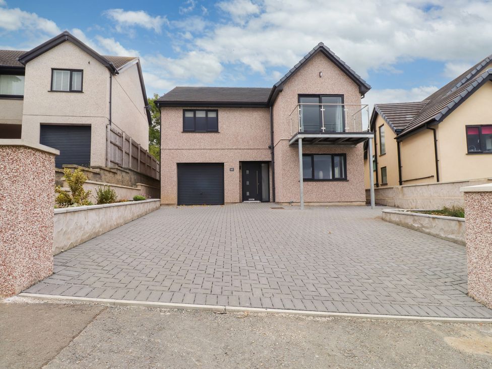 A house with a driveway and balcony at 95 Cae America Llanfairfechan