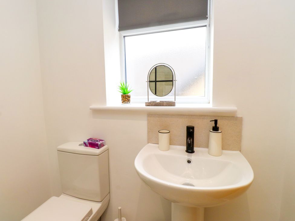 A bathroom with a sink and toilet at 95 Cae America in Llanfairfechan